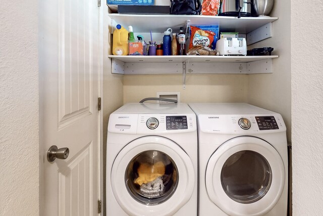 clothes washing area featuring independent washer and dryer