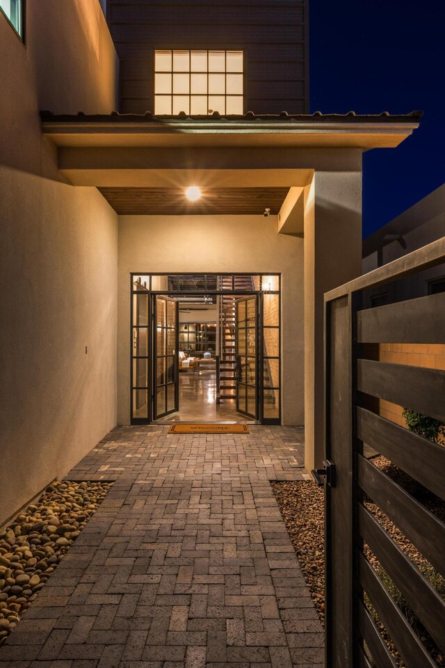 exterior entry at twilight featuring a patio area