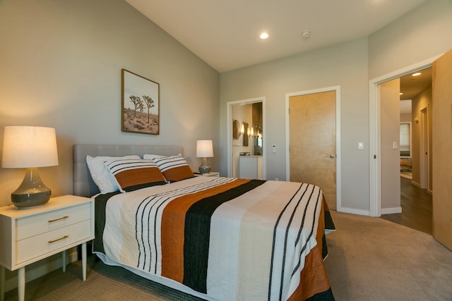 bedroom featuring dark colored carpet and connected bathroom