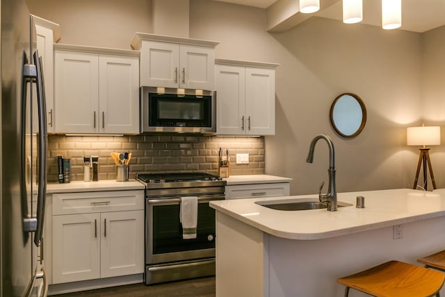 kitchen featuring pendant lighting, stainless steel appliances, and white cabinets