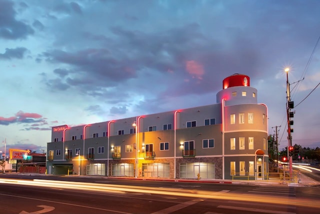 view of outdoor building at dusk