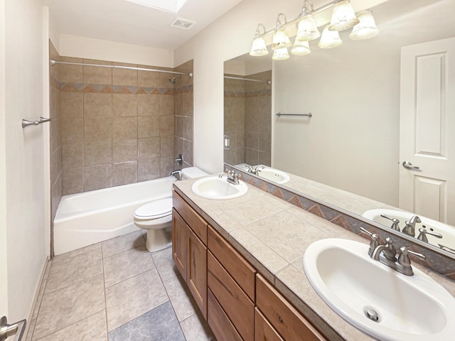 full bathroom with a skylight, vanity, tile patterned floors, toilet, and tiled shower / bath