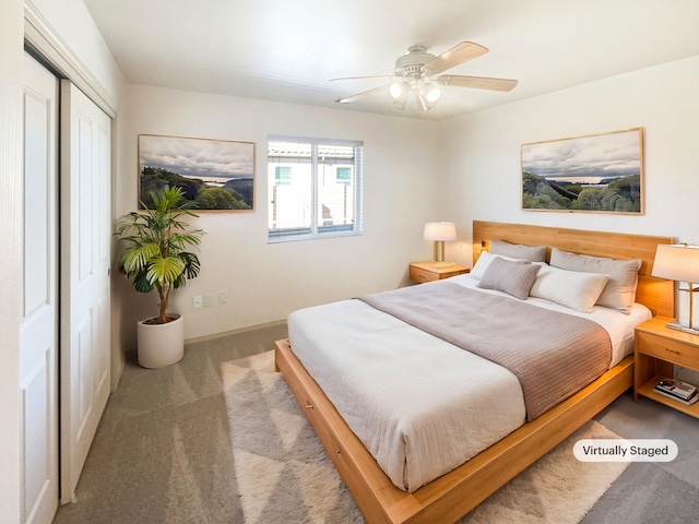 carpeted bedroom with ceiling fan and a closet