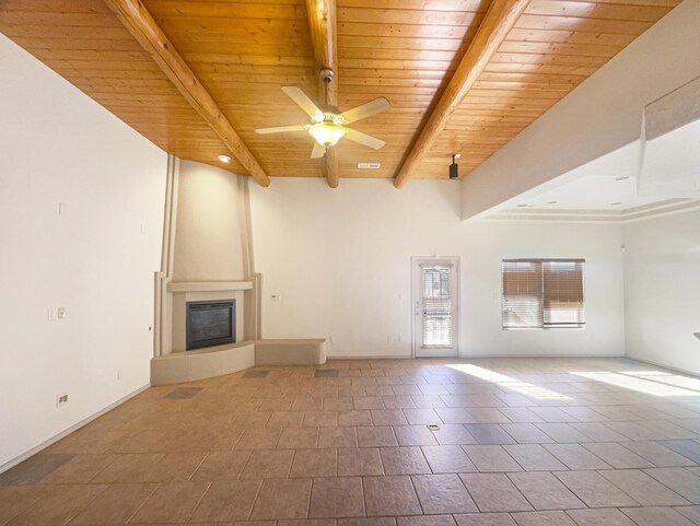 unfurnished living room featuring wood ceiling, a large fireplace, beam ceiling, and ceiling fan