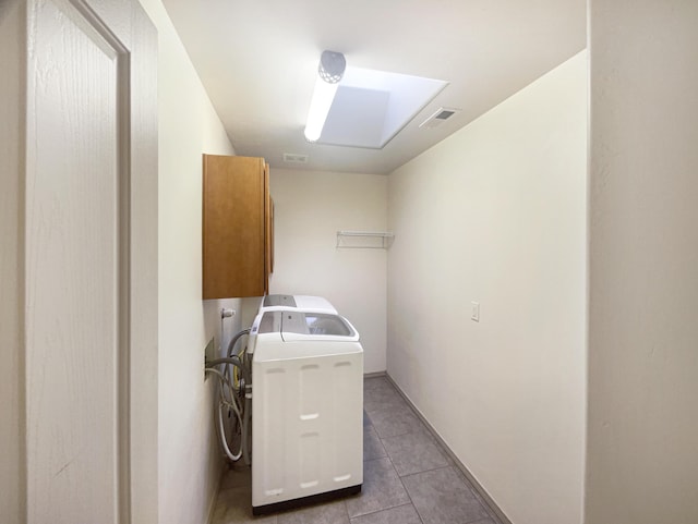 laundry room with tile patterned floors and cabinets