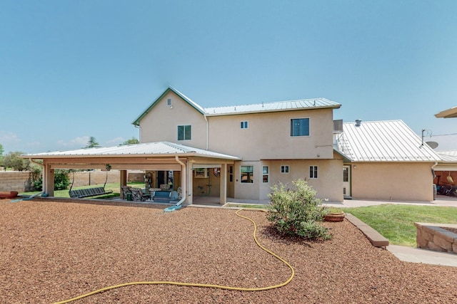 back of property with a gazebo and a patio area