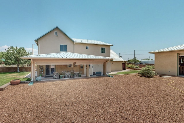 back of property featuring a patio area