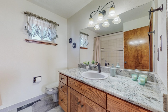 bathroom featuring a shower with shower curtain, vanity, toilet, and tile patterned flooring