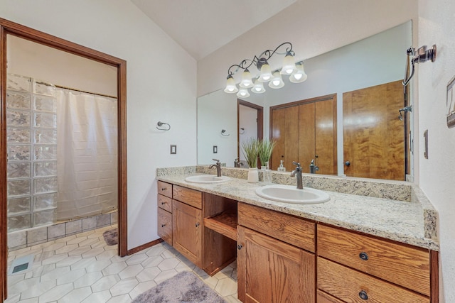 bathroom featuring lofted ceiling, vanity, and tile patterned flooring