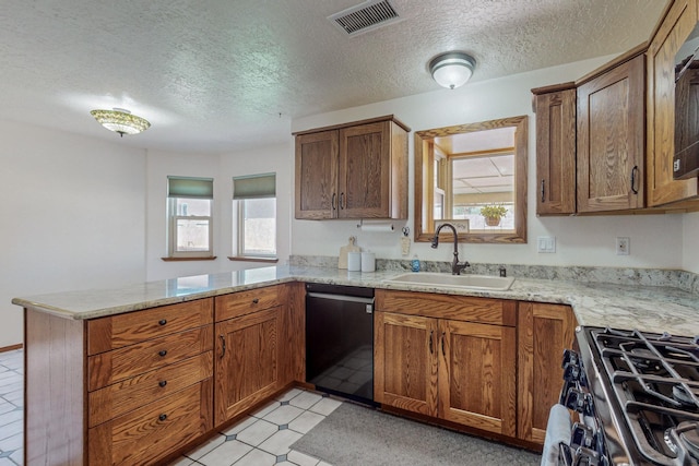 kitchen with sink, gas range, black dishwasher, kitchen peninsula, and light stone countertops