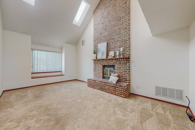 unfurnished living room featuring a fireplace, a skylight, high vaulted ceiling, and carpet