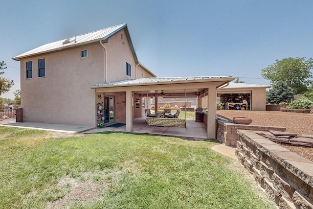 back of house featuring a patio and a lawn