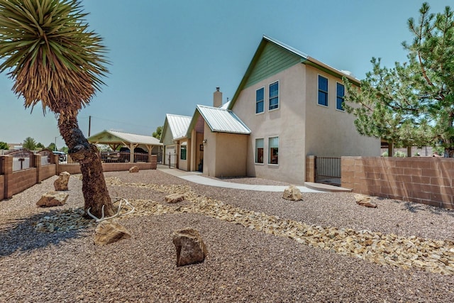 back of property with a gazebo