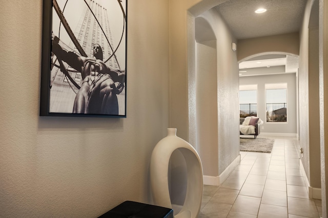 hall featuring light tile patterned floors