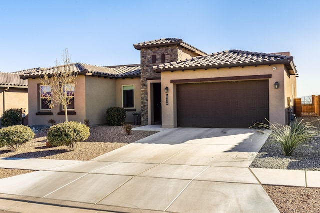 mediterranean / spanish home featuring a garage