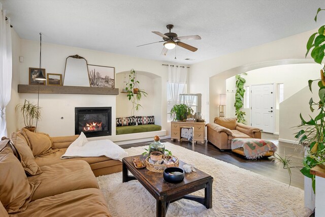 living room featuring ceiling fan and hardwood / wood-style floors