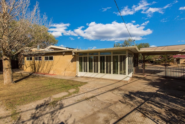 back of property with a sunroom