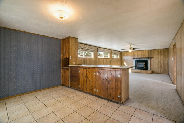 kitchen featuring light carpet, a textured ceiling, ceiling fan, and kitchen peninsula