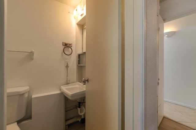 bathroom with sink, tile patterned floors, and toilet