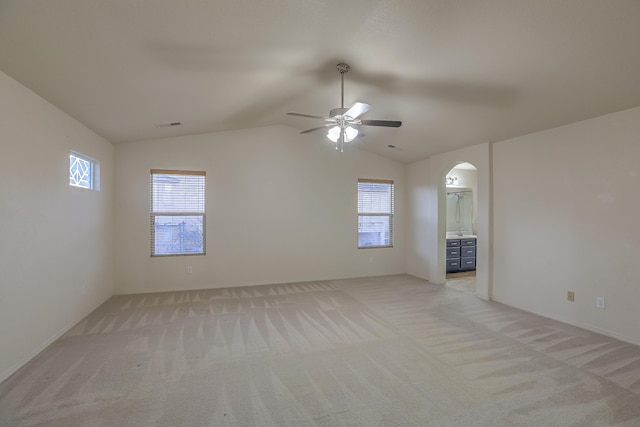 carpeted empty room with lofted ceiling and ceiling fan