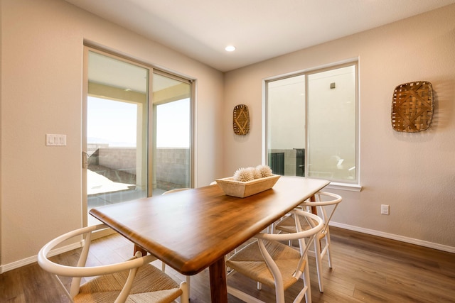 dining space featuring recessed lighting, baseboards, and wood finished floors