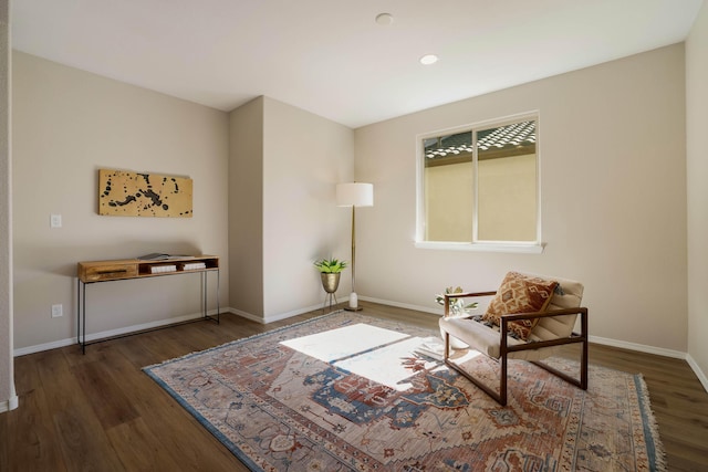 sitting room with dark wood-style floors and baseboards