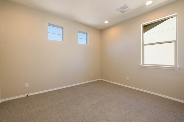 unfurnished room featuring carpet, visible vents, baseboards, and recessed lighting