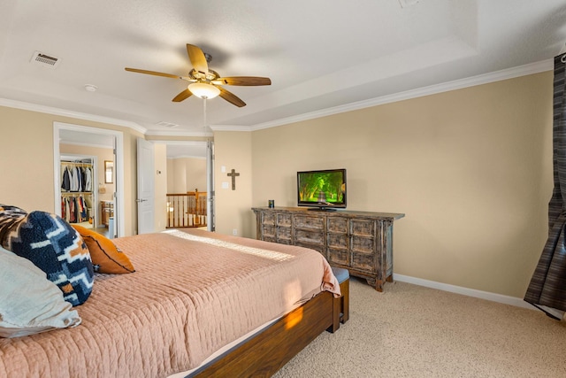 bedroom with crown molding, ceiling fan, and a spacious closet