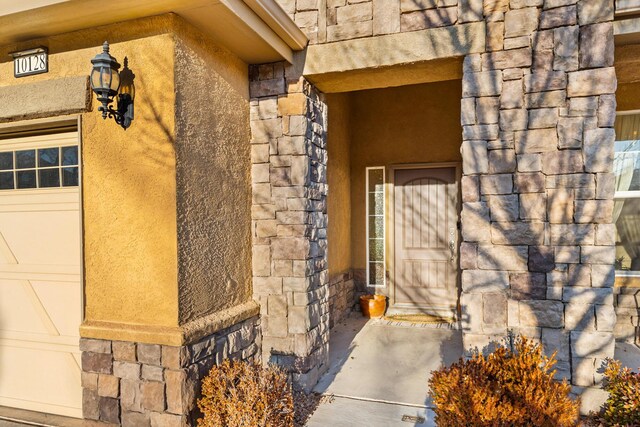 view of exterior entry with a garage