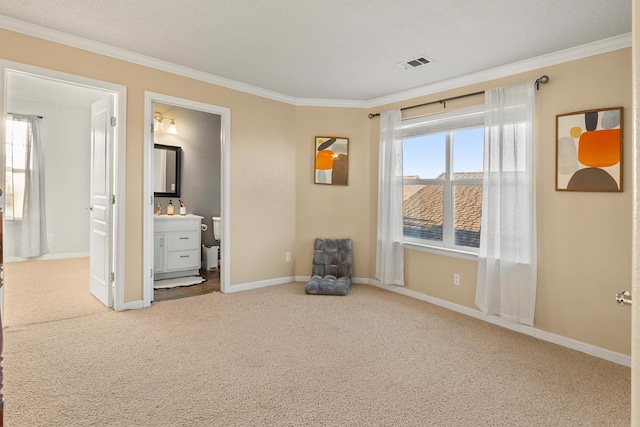 unfurnished bedroom with multiple windows, ornamental molding, ensuite bathroom, and carpet