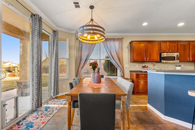 tiled dining room featuring ornamental molding and a notable chandelier