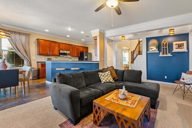 living room with crown molding, carpet, ceiling fan, and a textured ceiling