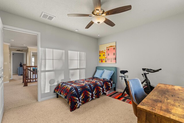 bedroom with crown molding, ceiling fan, and carpet flooring