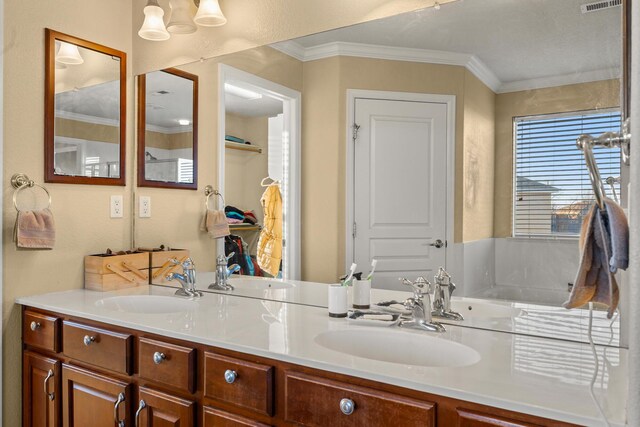 bathroom with ornamental molding and vanity