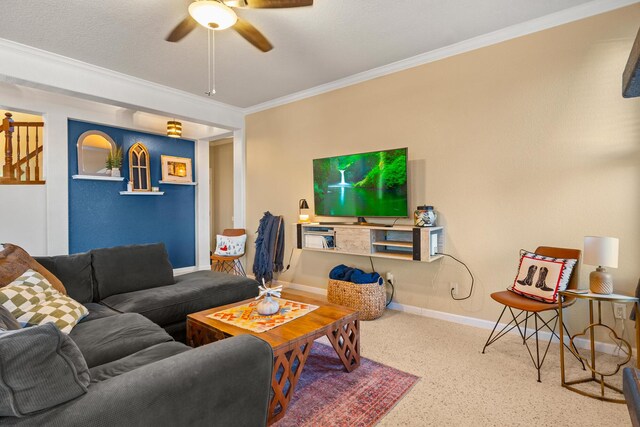 living room with ornamental molding and ceiling fan