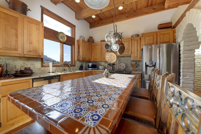 kitchen featuring appliances with stainless steel finishes, sink, tile countertops, wooden ceiling, and beam ceiling