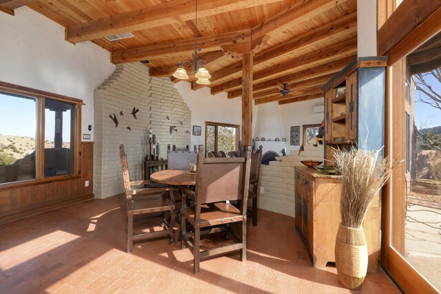 dining area featuring wood ceiling, a towering ceiling, a wealth of natural light, and beam ceiling