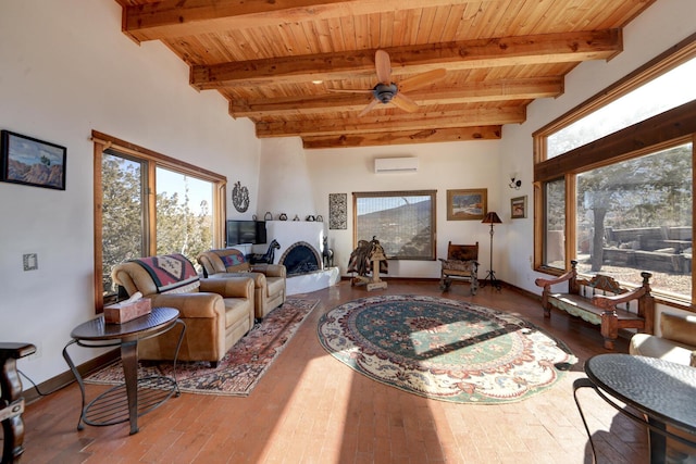 living room with an AC wall unit, ceiling fan, beam ceiling, and wood ceiling