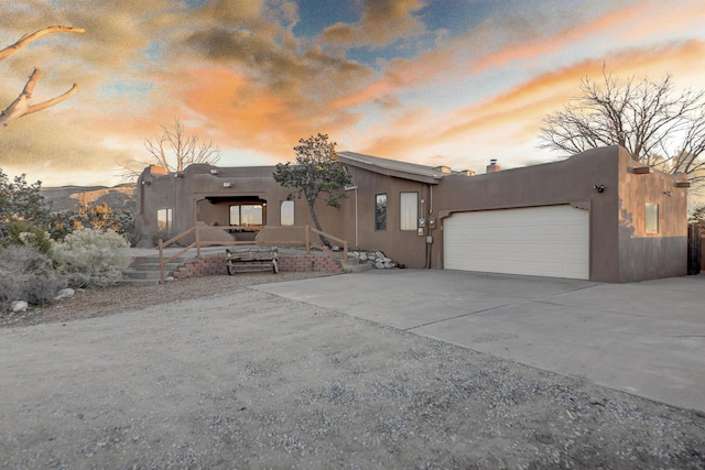 pueblo-style home featuring a garage