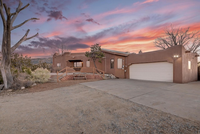 pueblo-style house with a garage