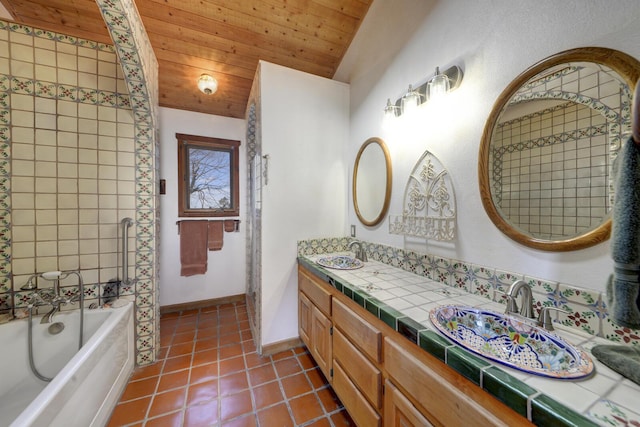 bathroom with vaulted ceiling, tile patterned floors, wood ceiling, vanity, and a washtub