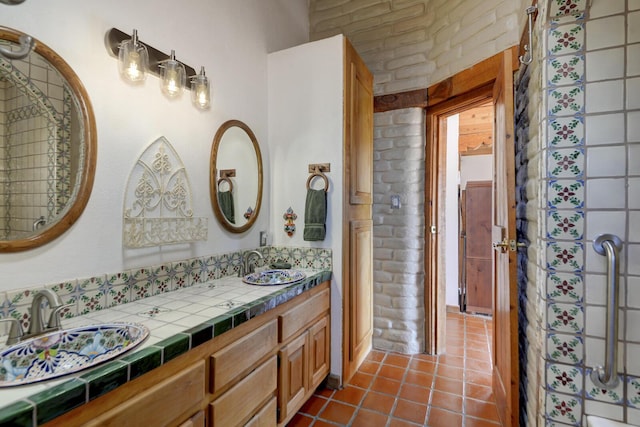 bathroom with vanity, brick wall, and tile patterned flooring