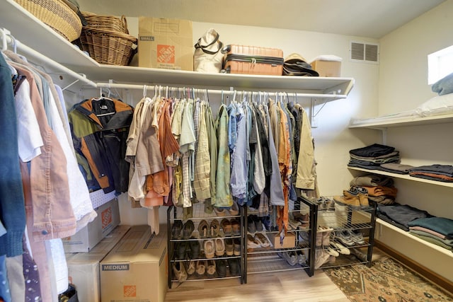 walk in closet with hardwood / wood-style floors