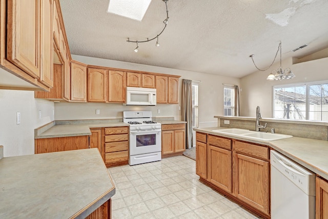 kitchen with pendant lighting, white appliances, a textured ceiling, sink, and lofted ceiling with skylight