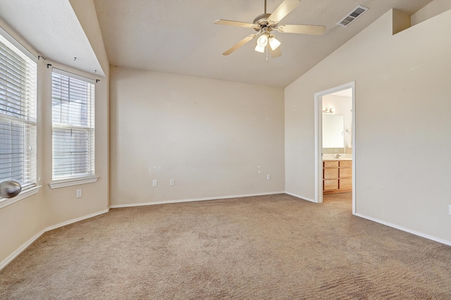 empty room with ceiling fan, light carpet, and lofted ceiling