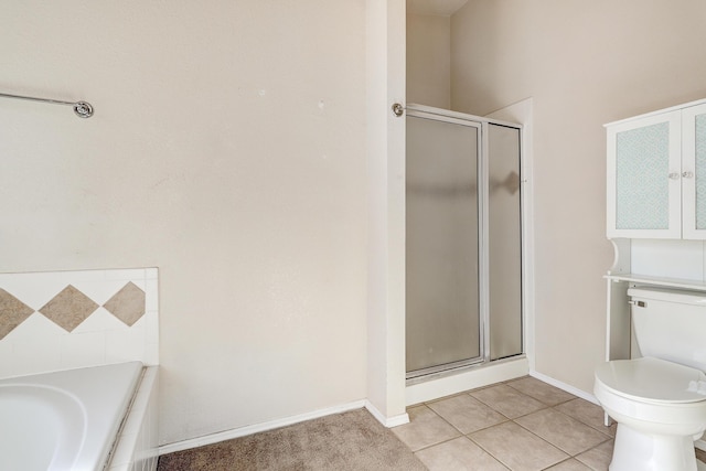 bathroom featuring tile patterned flooring, toilet, and shower with separate bathtub