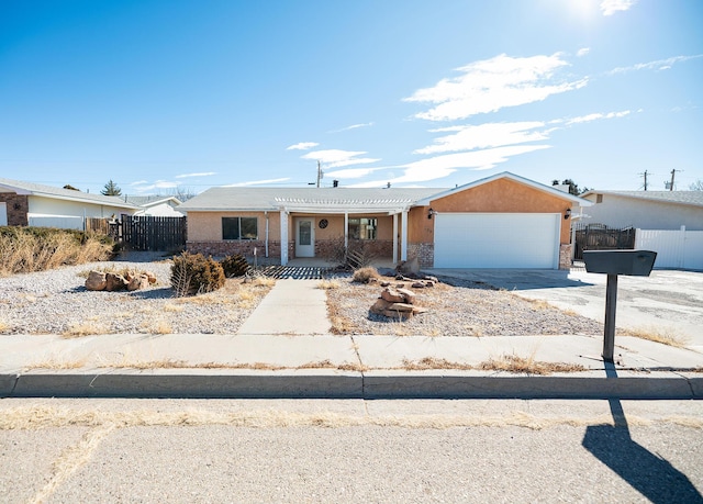 809 Kingman Ave, Grants, NM 87020 - single story home featuring a porch, brick siding, fence, concrete driveway, and an attached garage