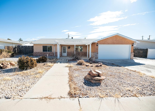 single story home with a garage and a pergola