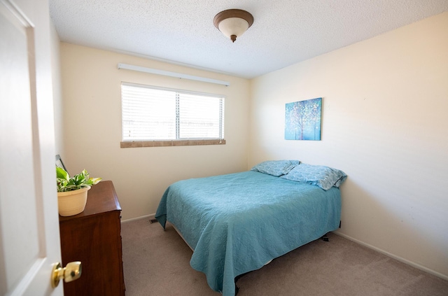 809 Kingman Ave, Grants, NM 87020 - bedroom featuring baseboards, carpet floors, and a textured ceiling