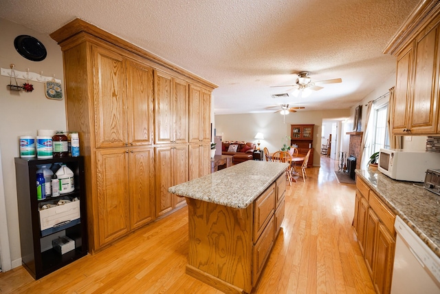 809 Kingman Ave, Grants, NM 87020 - kitchen with white appliances, a ceiling fan, light wood-style flooring, and a center island
